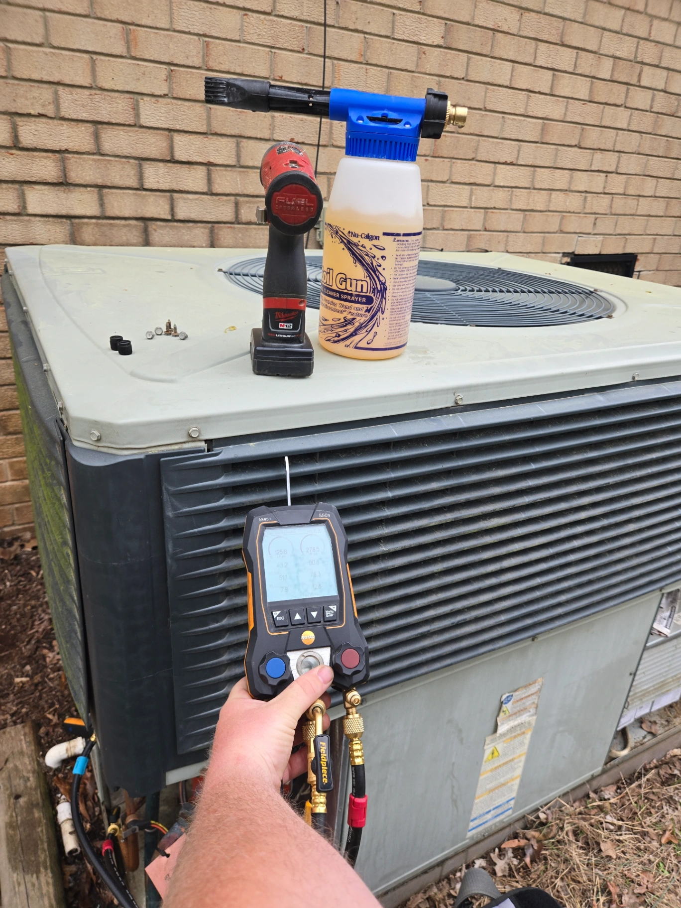 HVAC technician checking refrigerant pressure in River Haven