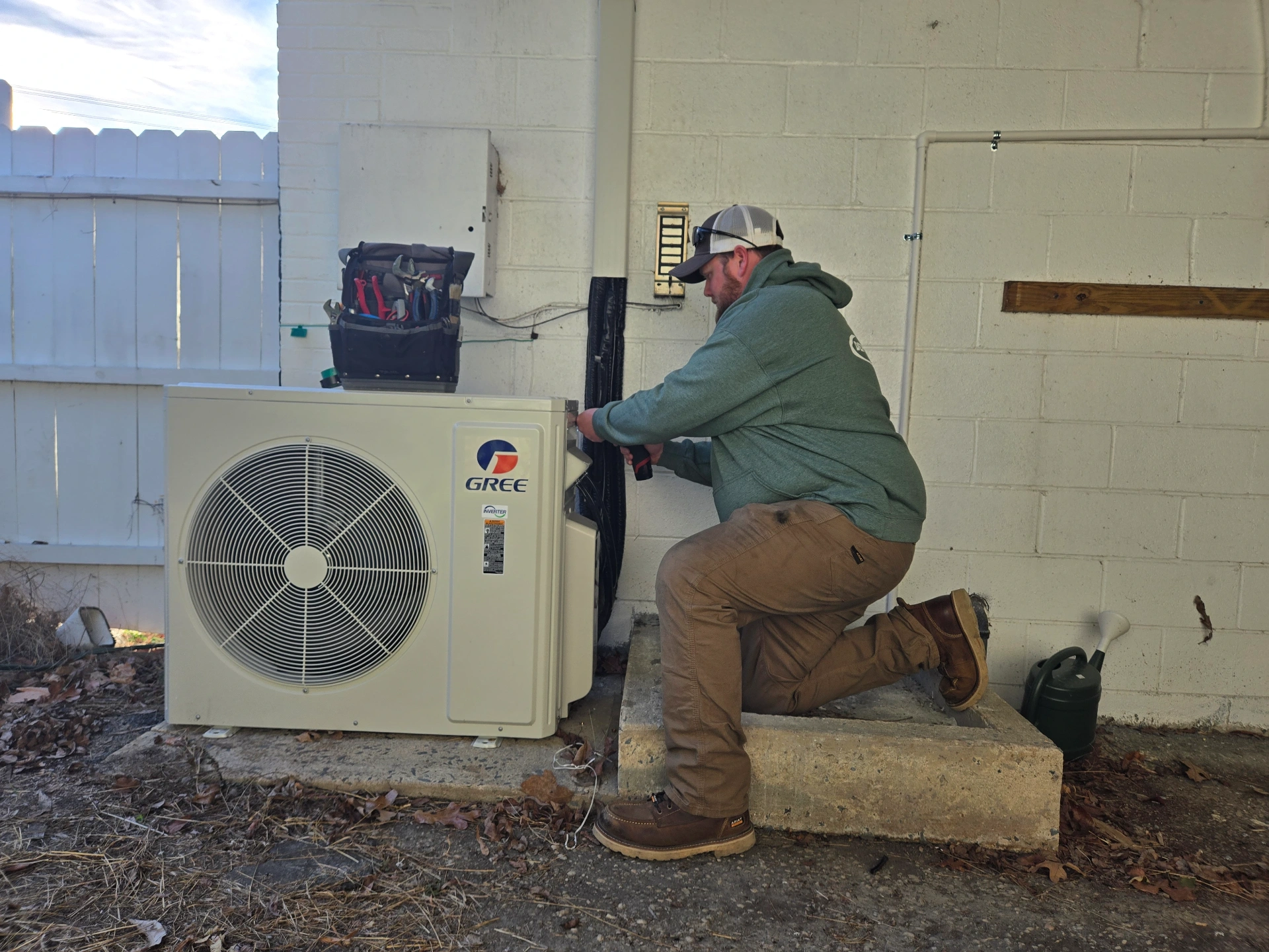Dependable HVAC technician working on outdoor unit in Albemarle NC